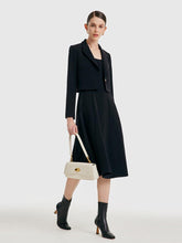 A bag-carrying woman wears a modal fabric dress.